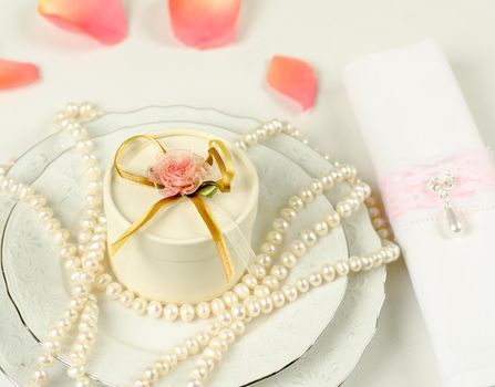 Pearls and flower petals at a decoration for wedding table
