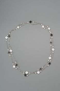 Beautiful fashion jewellery necklace bracelet on gray background