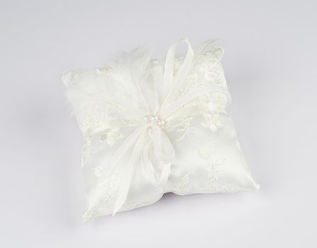 Exquisite pillow for wedding rings on gray background