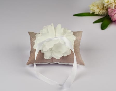 Brown pillow for wedding rings with flower