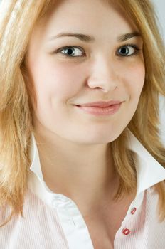 Portrait of a beautiful blond girl at the studio smiling