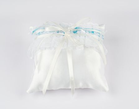 Exquisite pillow for wedding rings on gray background