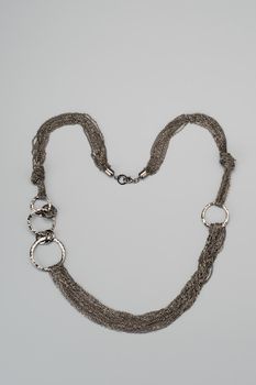 Luxury silver necklace on gray background