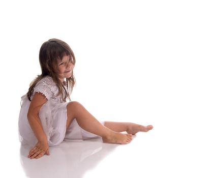 Portrait of a happy 5 years old girl sitting on a floor