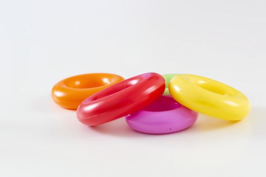 a group of of five colorful plastic rings isolated on a white background. Children's toys. Same size for each ring