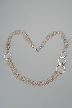 Luxury silver necklace on gray background