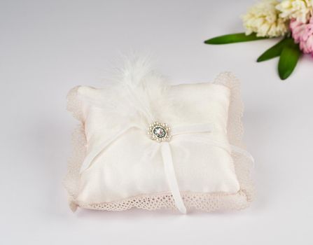 Exquisite pillow for wedding rings on gray background