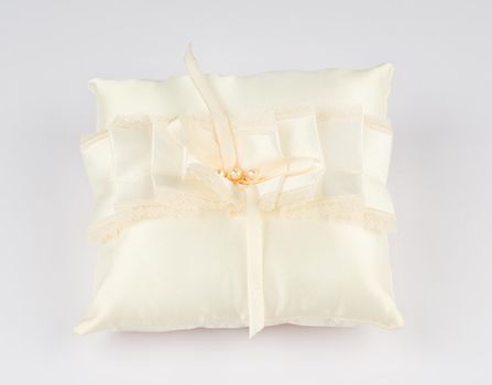 Exquisite pillow for wedding rings on gray background