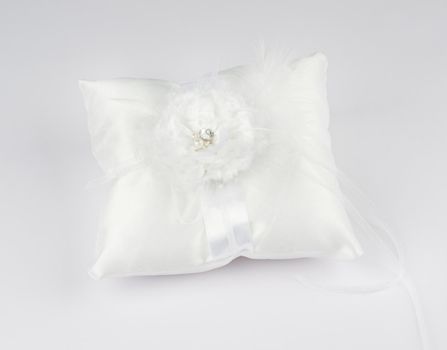 Exquisite pillow for wedding rings on gray background