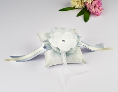 Exquisite pillow for wedding rings on gray background