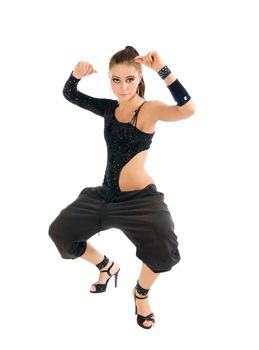 Beautiful modern dancer wearing black clothes dancing on white