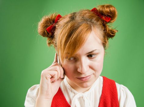 Red girl with mobile phone calling on green background