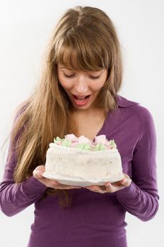 Beautiful young woman with delicious candy over plain background