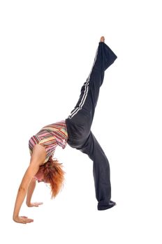 Red haired girl performing fitness exercises on white background