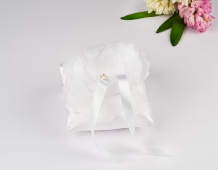 Exquisite pillow for wedding rings on gray background