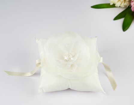 Exquisite pillow for wedding rings on gray background