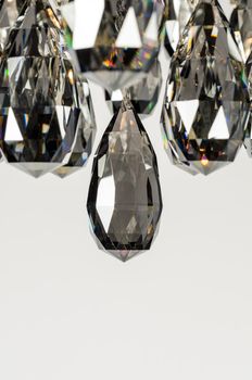 Contemporary glass chandelier crystals over white background