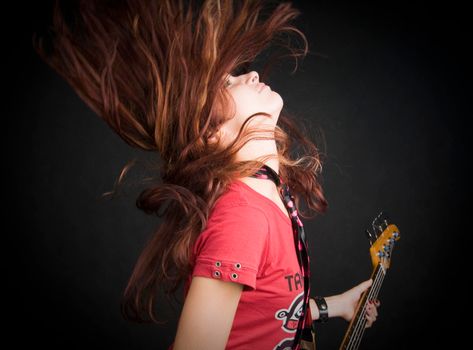 Portrait of a beautiful red haired girl on black background