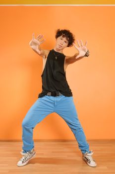 Young hip-hop performer posing on vivid background