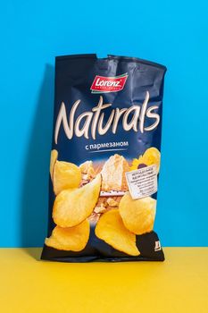 Tyumen, Russia-June 21, 2021: Lorenz Naturals parmesan cheese potato chips bag. Naturals produced by Lorenz Snack-World. Vertical photo