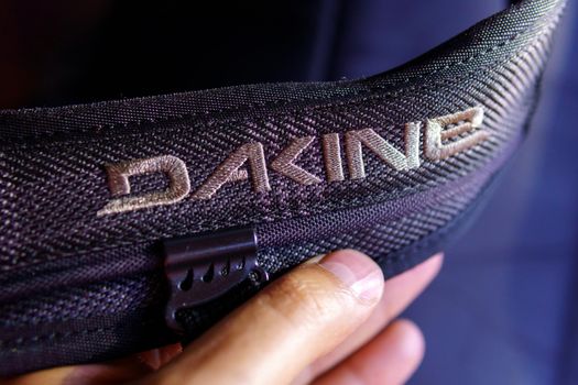 Tyumen, Russia-August 12, 2021: Dakine logo close-up. The Dakine brand appeared in 1979.