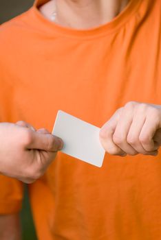Man in casual clothing gives his blank card to another man.
