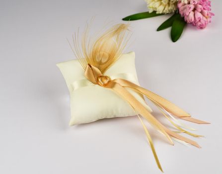 Exquisite pillow for wedding rings on gray background
