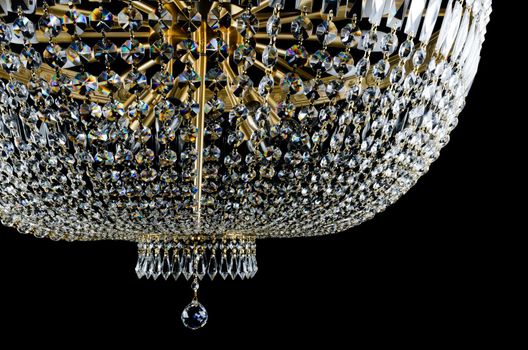 Closeup view of Contemporary glass chandelier isolated over black background
