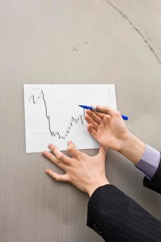 Buisenessman hands on the barrel background holding marker and prepearing to add chart marks