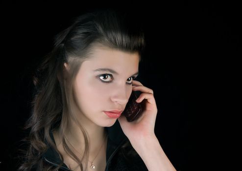 Beautiful girl talking on the phone looking away frorm camera