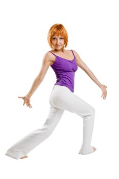 Red haired girl performing fitness exercises on white background