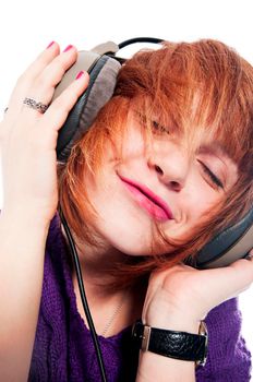 Beautiful girl listening to the music isolated on white