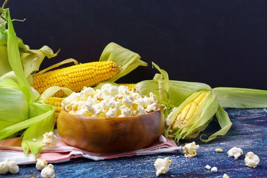 Fresh corn and popcorn on cobs on black background. close up. Copyspace