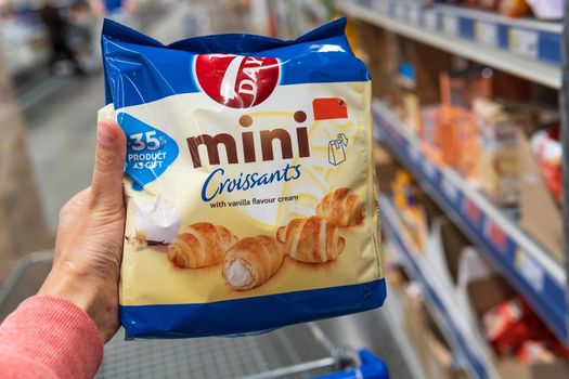 Tyumen, Russia-june 08, 2021: 7days croissant with a grocery hypermarket in the buyer's hand. Selective focus