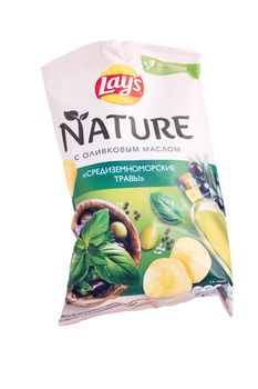 Tyumen, Russia-May 25, 2021: Lays chips nature with olive oil and Mediterranean herbs. On white background