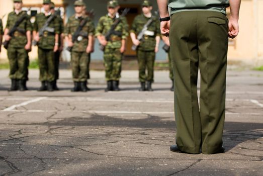 From behind view of an officer commanding soldiers