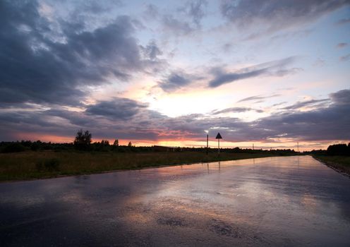 Countryside road with reflections of a sunset