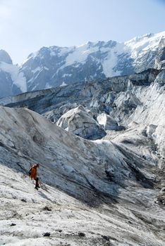 Mountaineer crossing ice canyon