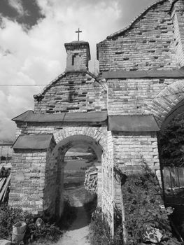 Old cemetery. The entrance was shot with red photofilter for maximum contrast in black and white