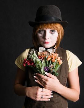 Sad clown with bouquet