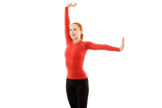 Beautiful young red woman performing fitness exercises over white background