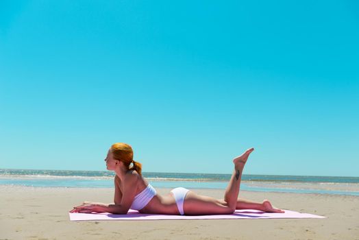 Sexy red woman wearing bikini on a beach