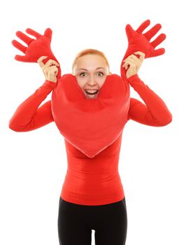 Cheerful young woman with big toy heart pillow
