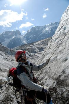 Young mountaineer is working out on a glacier during training courses