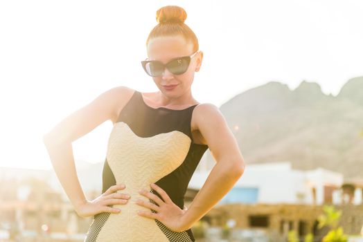 Young cool fashion woman posing over blue sky