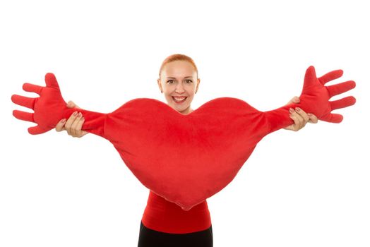 Cheerful young woman with big toy heart