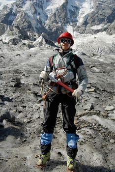 Young mountaineer is standing on a glacier during training courses