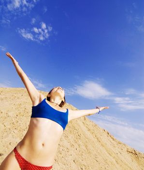 Young healthy-looking girl is excited about summer on a beach