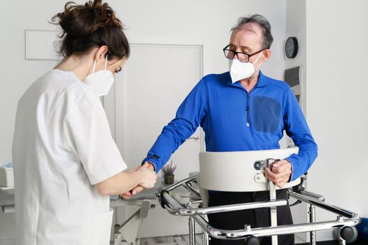 female nurse caregiver, holding patient hand, support disabled patient sit on wheelchair at hospital, young doctor carer help paralyzed patient. High quality photo