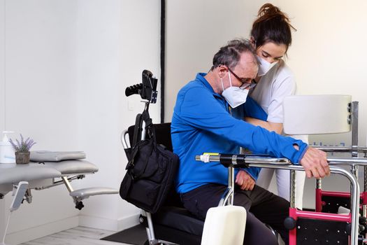 female nurse caregiver, holding patient hand, support disabled patient sit on wheelchair at hospital, young doctor carer help paralyzed patient. High quality photo